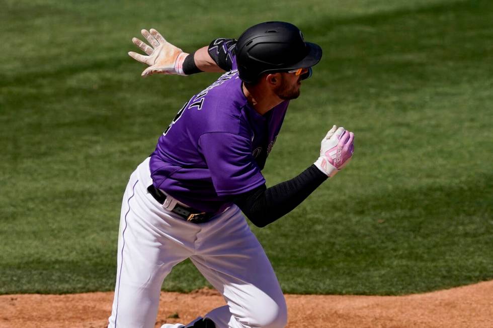 Colorado Rockies left fielder Kris Bryant (23) hits against the Los Angeles Dodgers during the ...