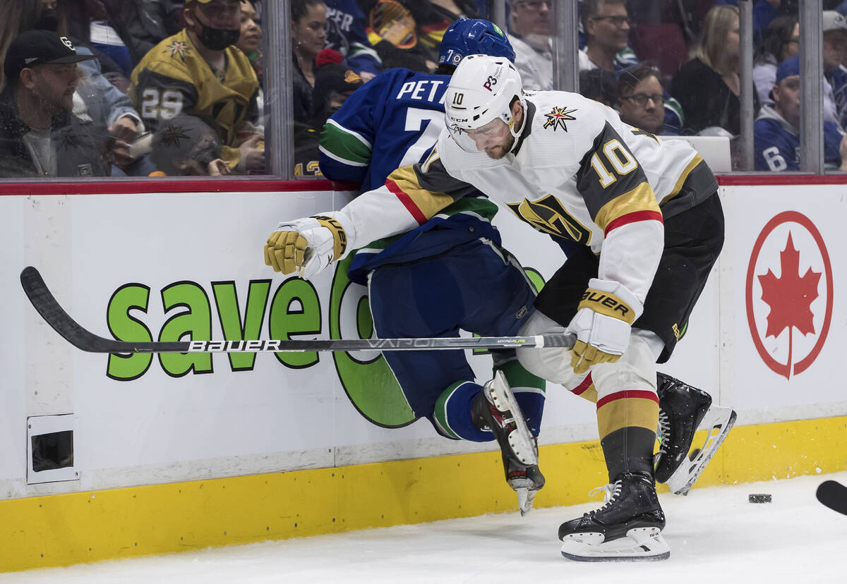 Vegas Golden Knights' Nicolas Roy (10) checks Vancouver Canucks' Nic Petan (7) during the third ...