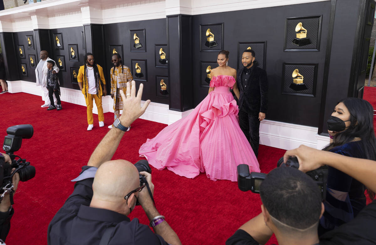 John Legend, top/right, and wife Chrissy Teigen on the red carpet before the start of the 2022 ...