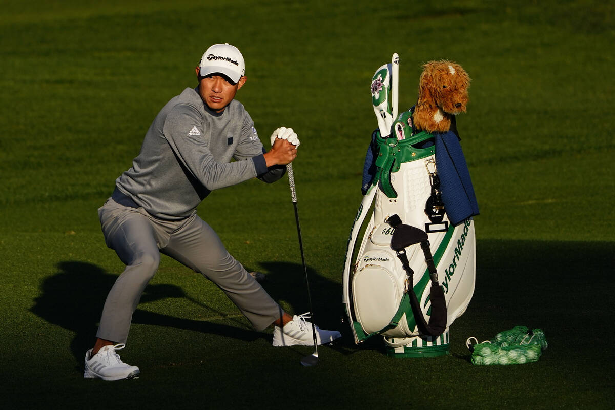 Collin Morikawa stretches before hitting on the driving range during a practice round for the M ...