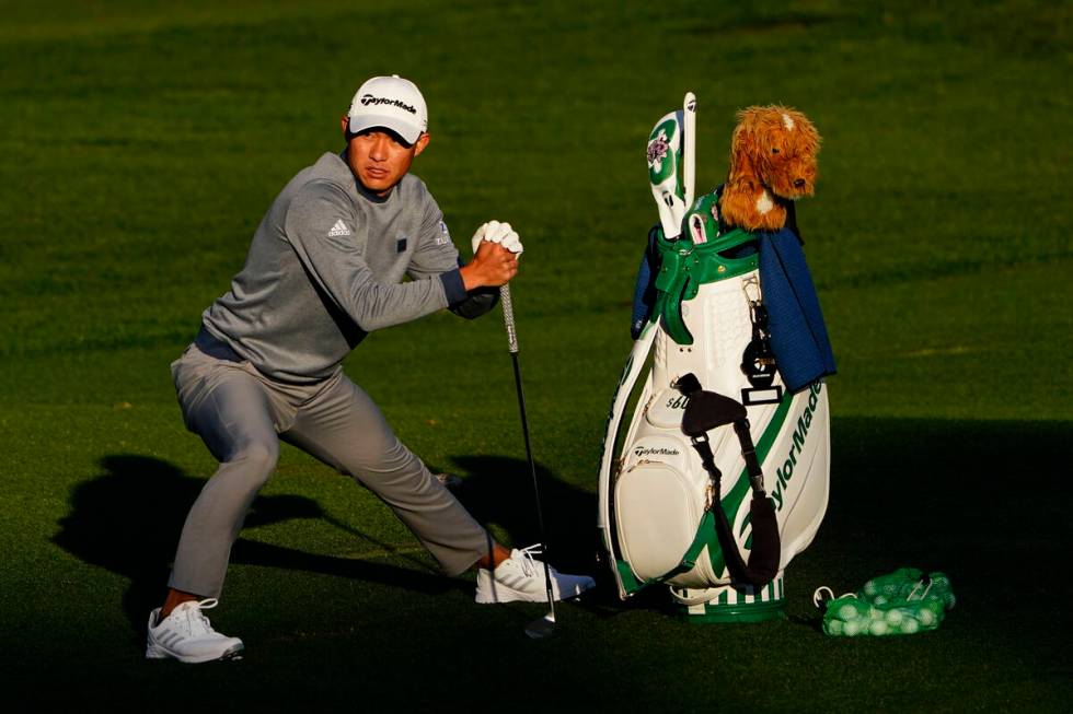 Collin Morikawa stretches before hitting on the driving range during a practice round for the M ...