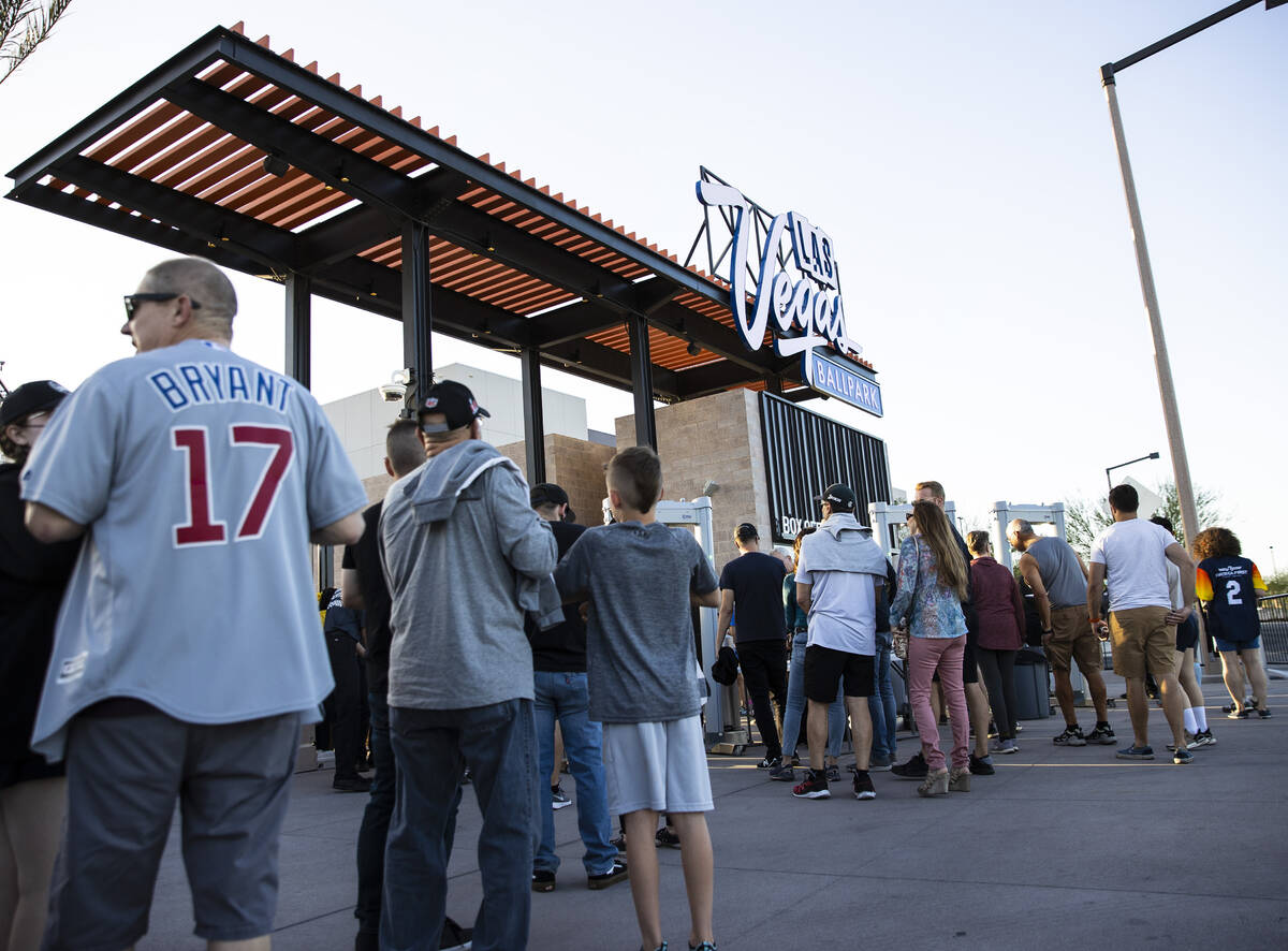 Fans wait in line to attend the Las Vegas Aviators home opener game against Reno Aces at the La ...