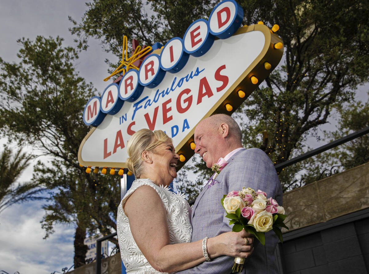 Paul and Linda Phillips, from Essex, England, pose for a photo in front of the wedding-inspired ...