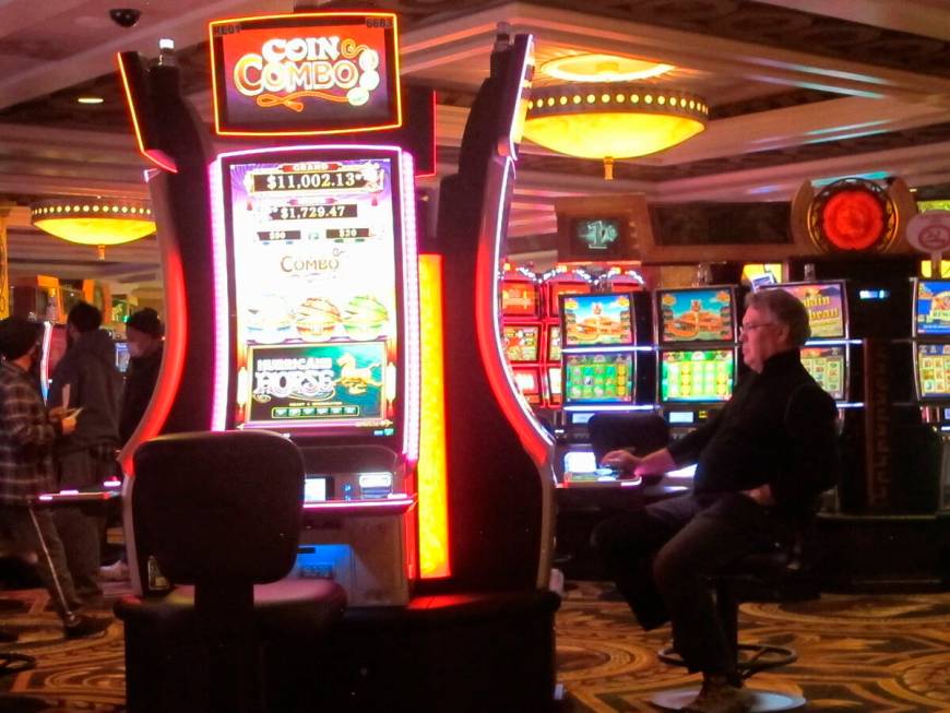 This Jan. 27, 2022, photo shows a gambler playing a slot machine at Caesars casino in Atlantic ...