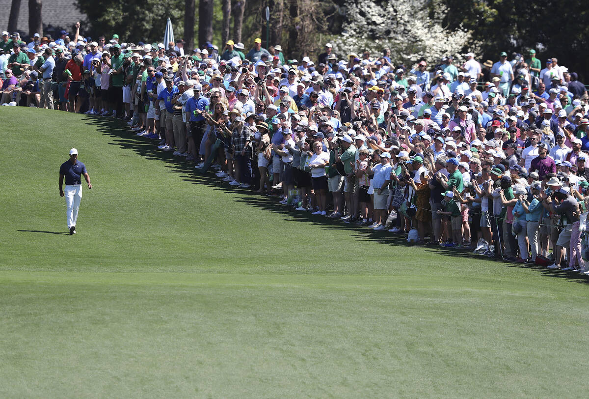 The giant gallery of patrons following five-time Masters champion Tiger Woods applaude as he wa ...