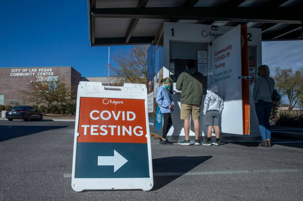 People wait and are served for COVID-19 testing at the Veterans Memorial Community Center on Tu ...