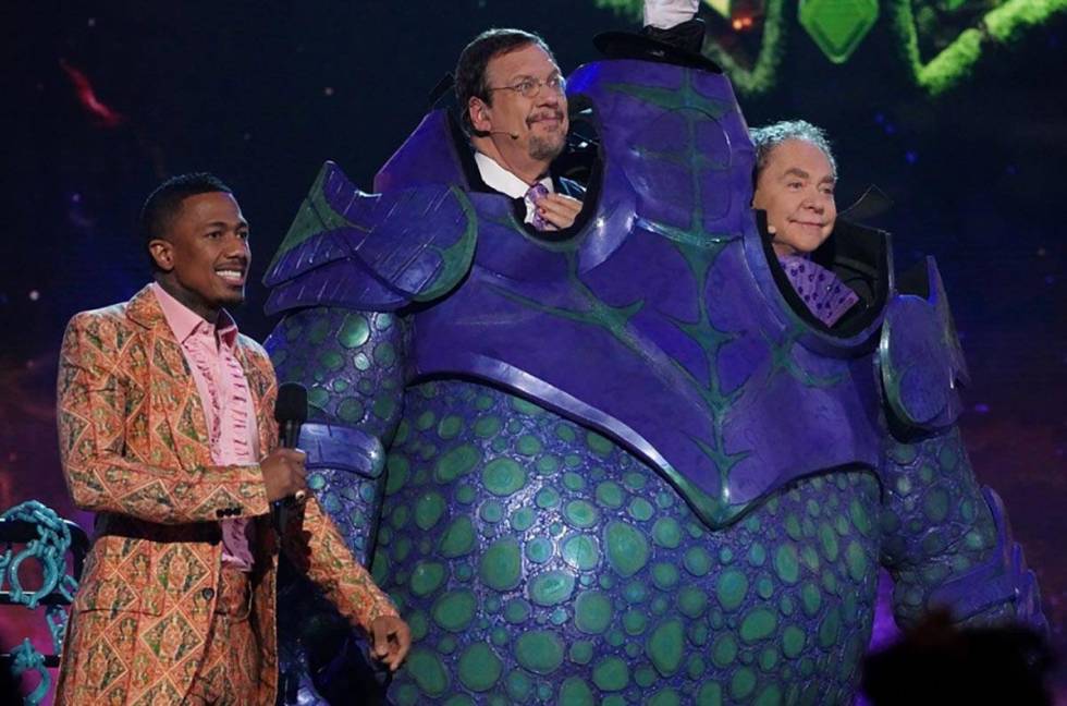 "The Masked Singer" host Nick Cannon is shown with Penn & Teller after being eliminated and unm ...