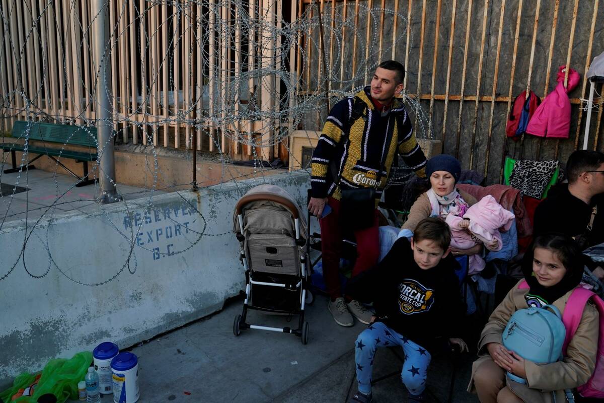 Ukrainian refugees wait at the border Monday, April 4, 2022, in Tijuana, Mexico. (AP Photo/Greg ...
