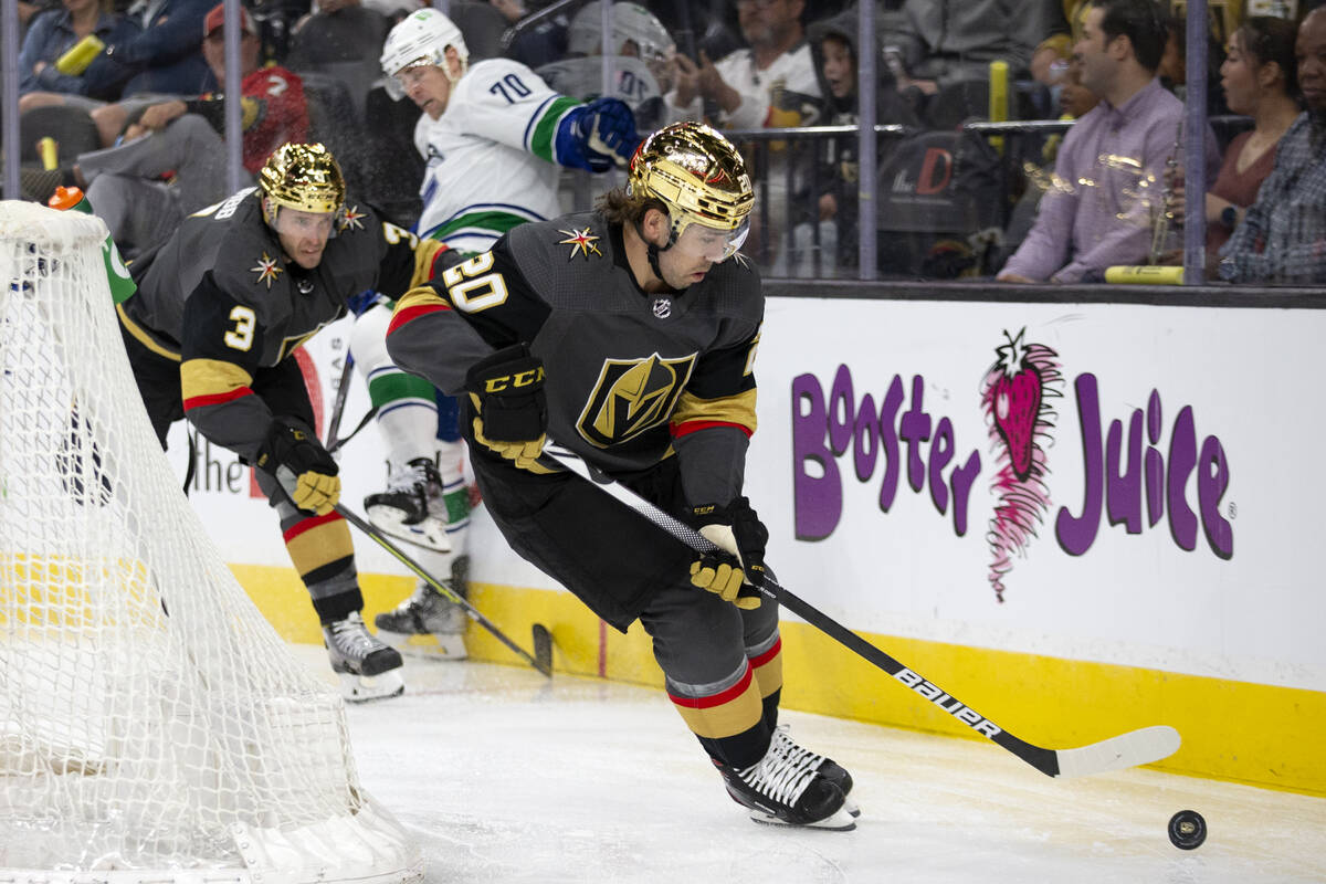 Golden Knights center Chandler Stephenson (20) skates with the puck while defenseman Brayden Mc ...