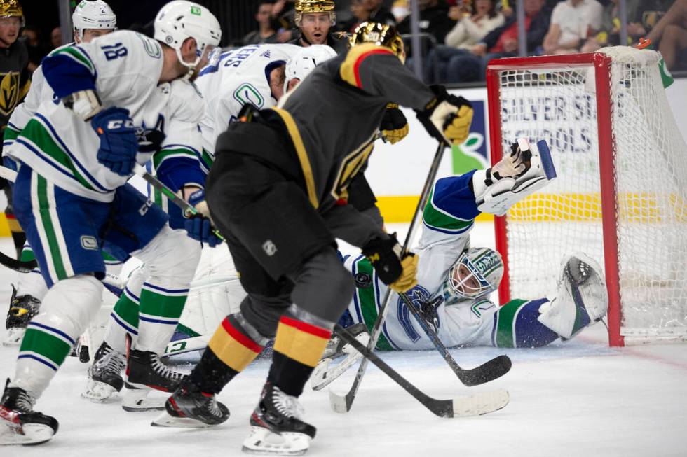 Canucks goaltender Thatcher Demko (35) dives to save a shot by Golden Knights center Chandler S ...