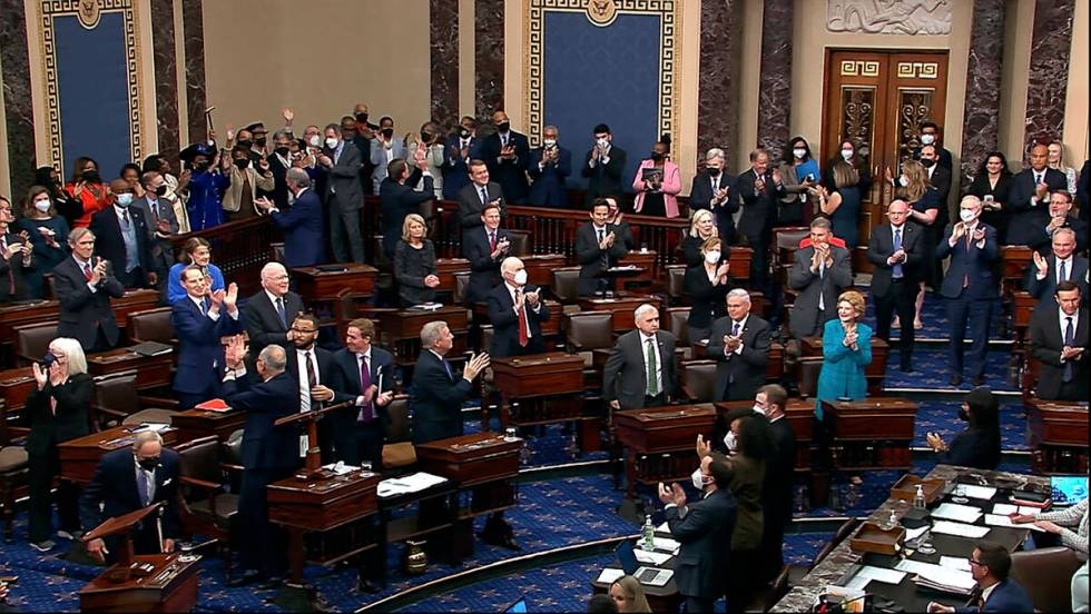 In this image from video from Senate Television, Democrats stand and applaud after the Senate c ...