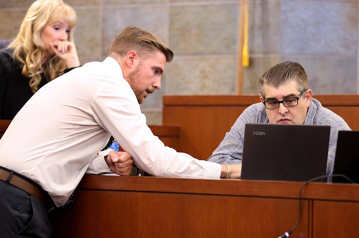 Defense attorney Dan Hill, center, shows surveillance video to Robert Alexander on the witness ...