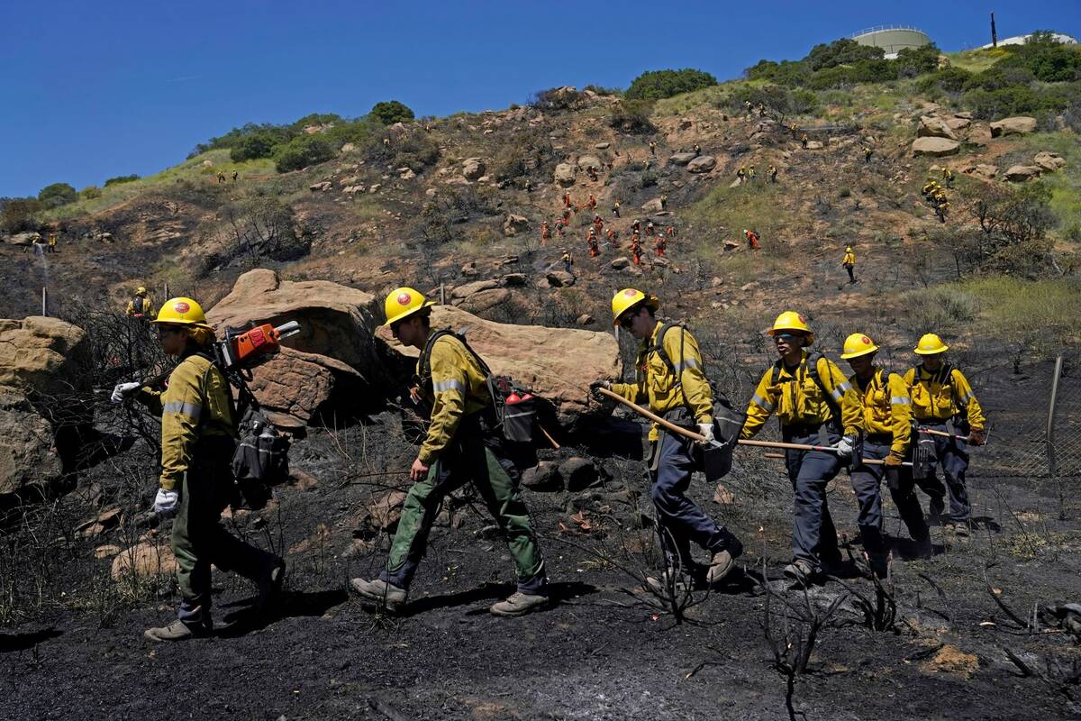 Crews battle a brush fire along the 118 freeway Wednesday, April 6, 2022, in Chatsworth, Calif. ...
