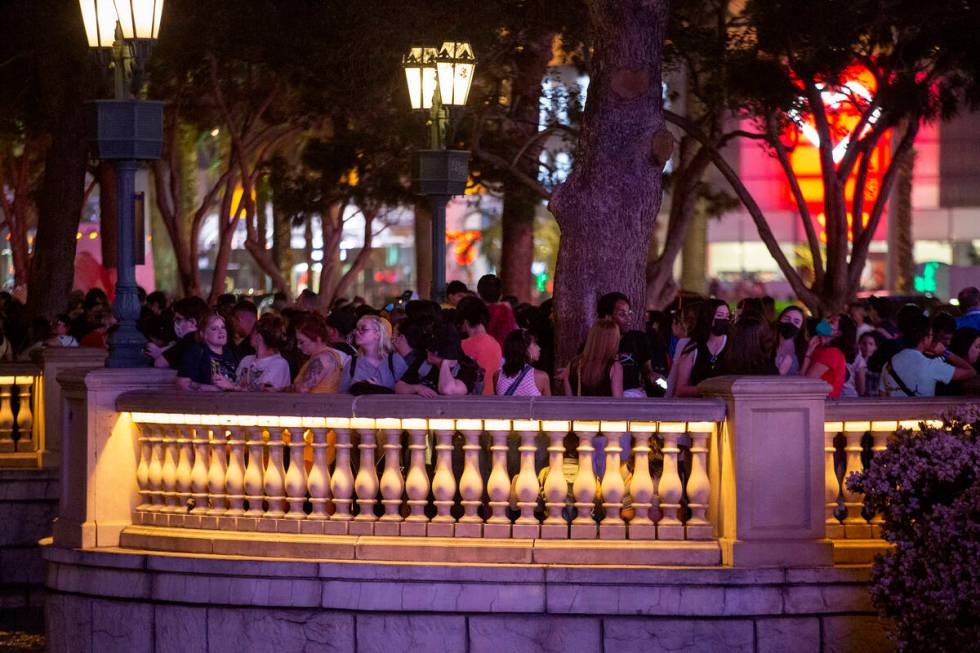 A crowd forms at Bellagio Fountain before the show features songs “Butter” and &# ...