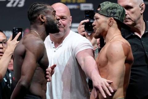 Opponents Aljamain Sterling, left, and Petr Yan of Russia face off during the UFC 273 ceremonia ...