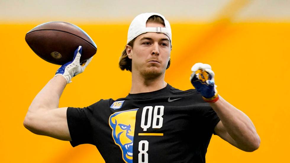 Pittsburgh quarterback Kenny Pickett (8) performs drills during Pittsburgh's football pro day , ...