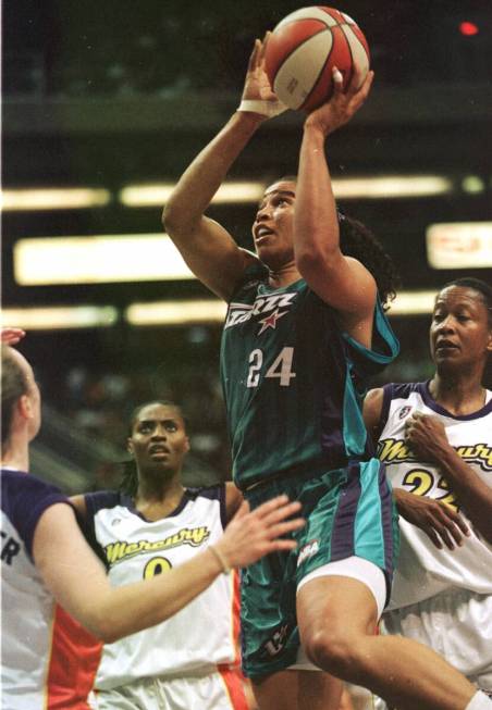 in this Aug. 20, 1999, file photo, Utah Starzz's Natalie Williams (24) drives toward the basket ...