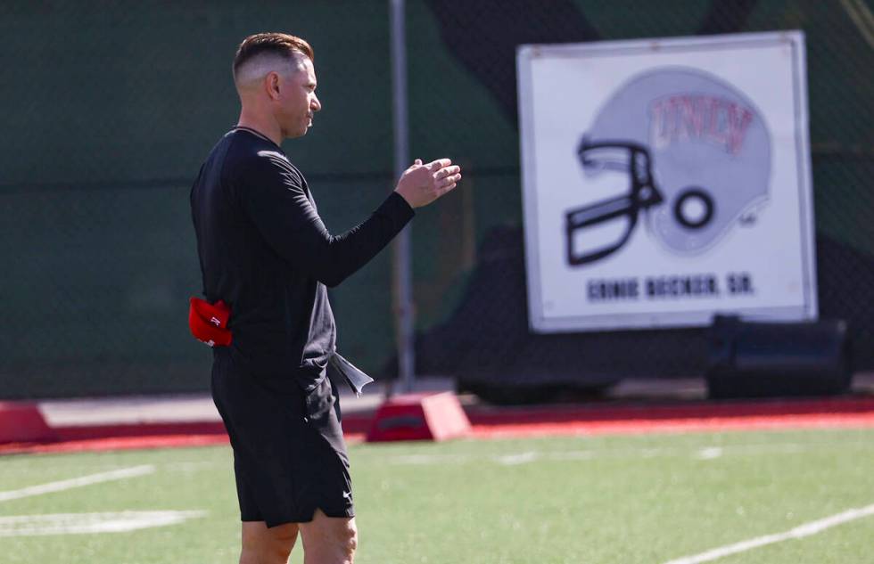 UNLV Rebels head coach Marcus Arroyo motions to players on during the first day of spring footb ...