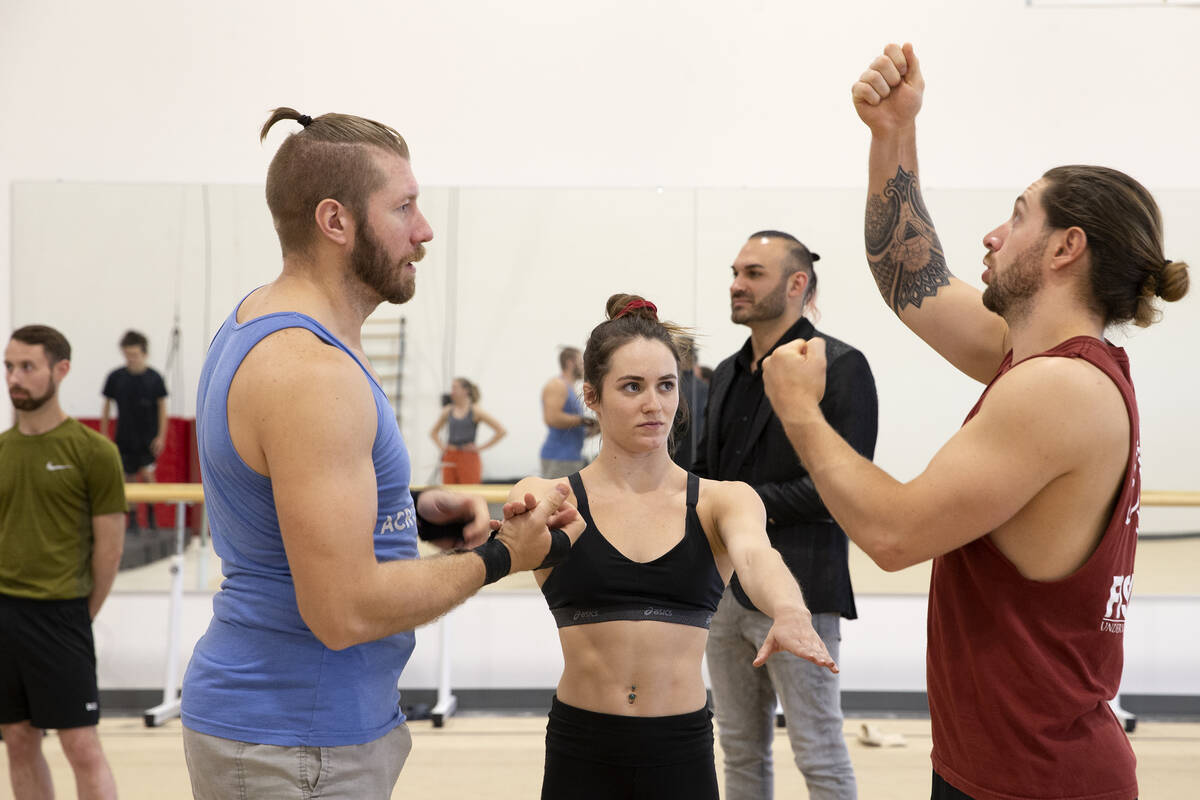 Scott Cooper, left, Casey Ely and Chris McGreevy, who perform in the teeterboard act, discuss a ...