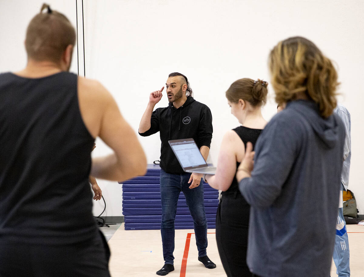 Producer and director of IGNITE Brandon Pereyda, second from left, discusses choreography with ...