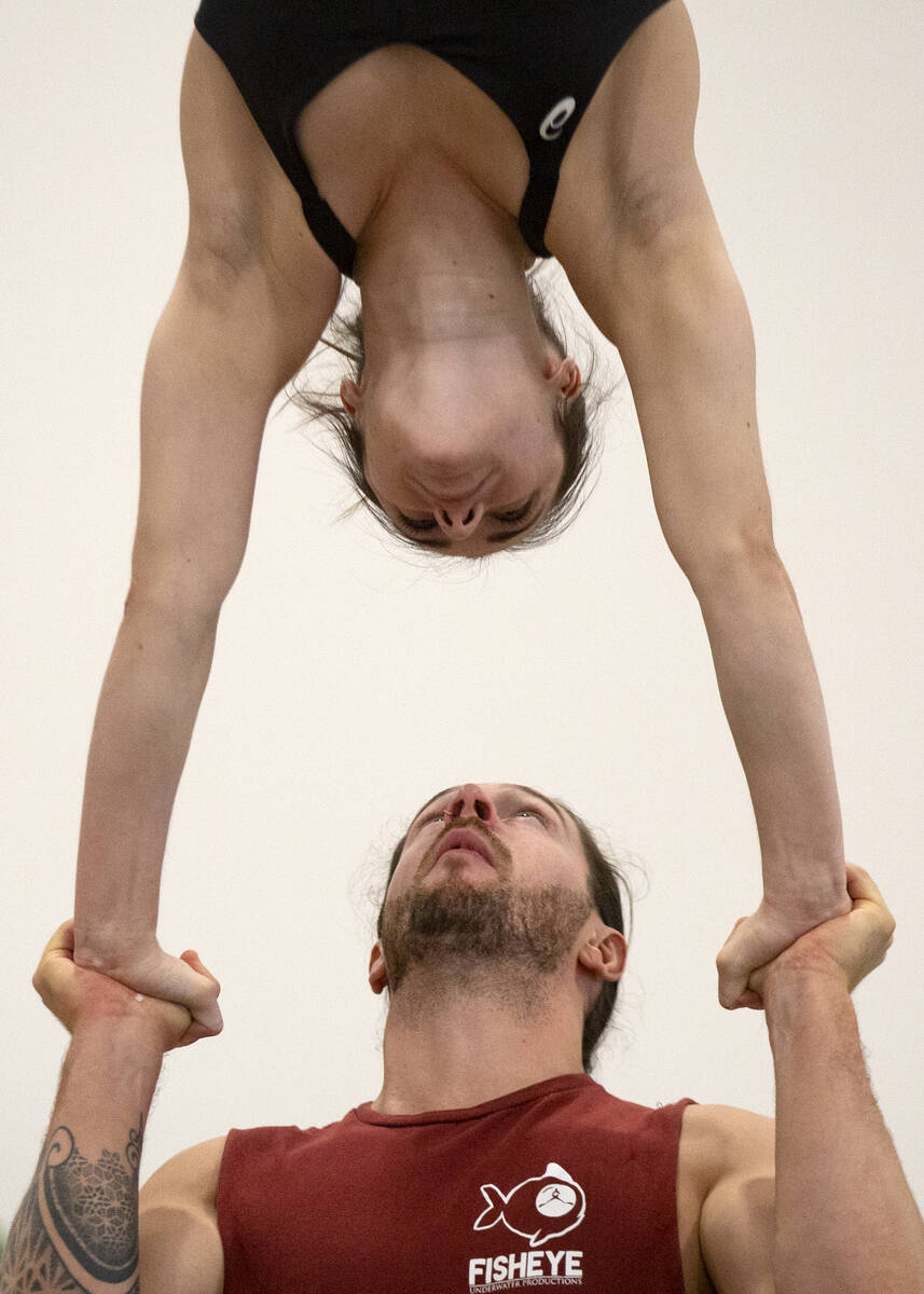 Chris McGreevy and Casey Ely practice a stunt in the teeterboard act during rehearsal for IGNIT ...