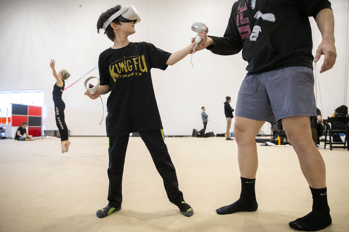 Nelson Sahagan practices for the Earth martial arts duet with his father Philip Sahagun during ...