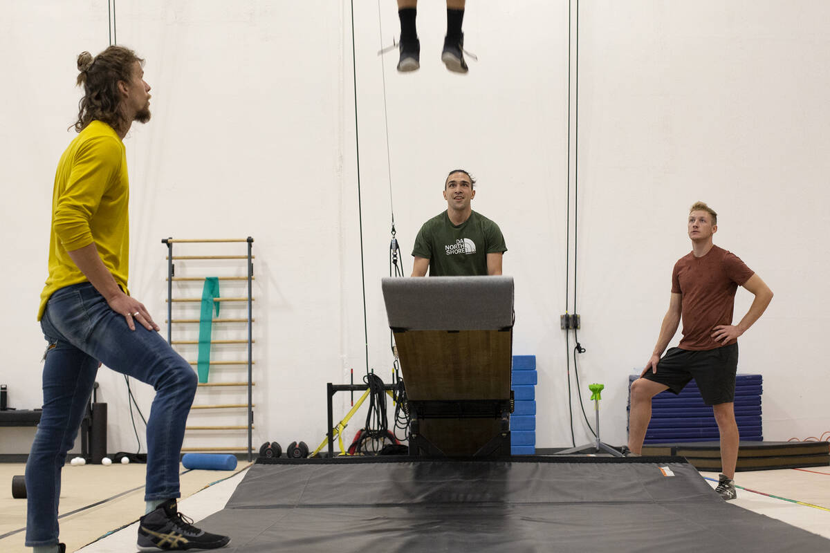 Teeterboard performers Dillon Vance, left, Alio Fan and Charles Keidel watch as their colleague ...