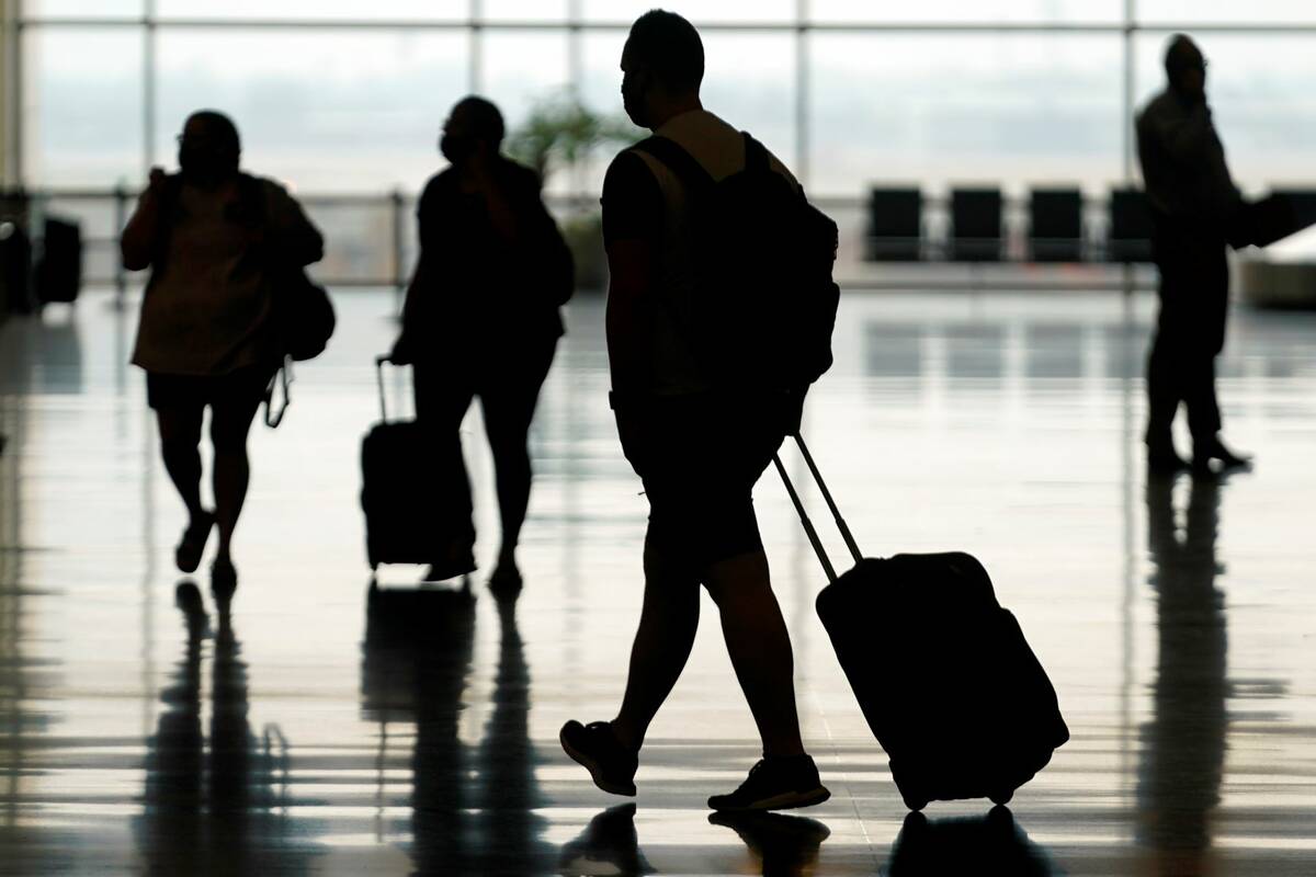 Travelers move through Salt Lake City International Airport on Aug. 17, 2021, in Salt Lake City ...