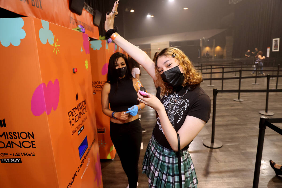 Jennifer Angelo of Las Vegas gets a photo card of a BTS band member during BTS LIVE PLAY at MGM ...