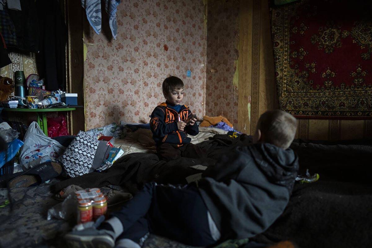 Vlad, 6, plays cards with a friend inside his house in Bucha, in the outskirts of Kyiv, Ukraine ...