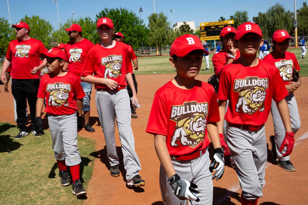 The Bulldogs, Sheriff Joe Lombardo’s team in the Bolden Little League, heads to the dugo ...