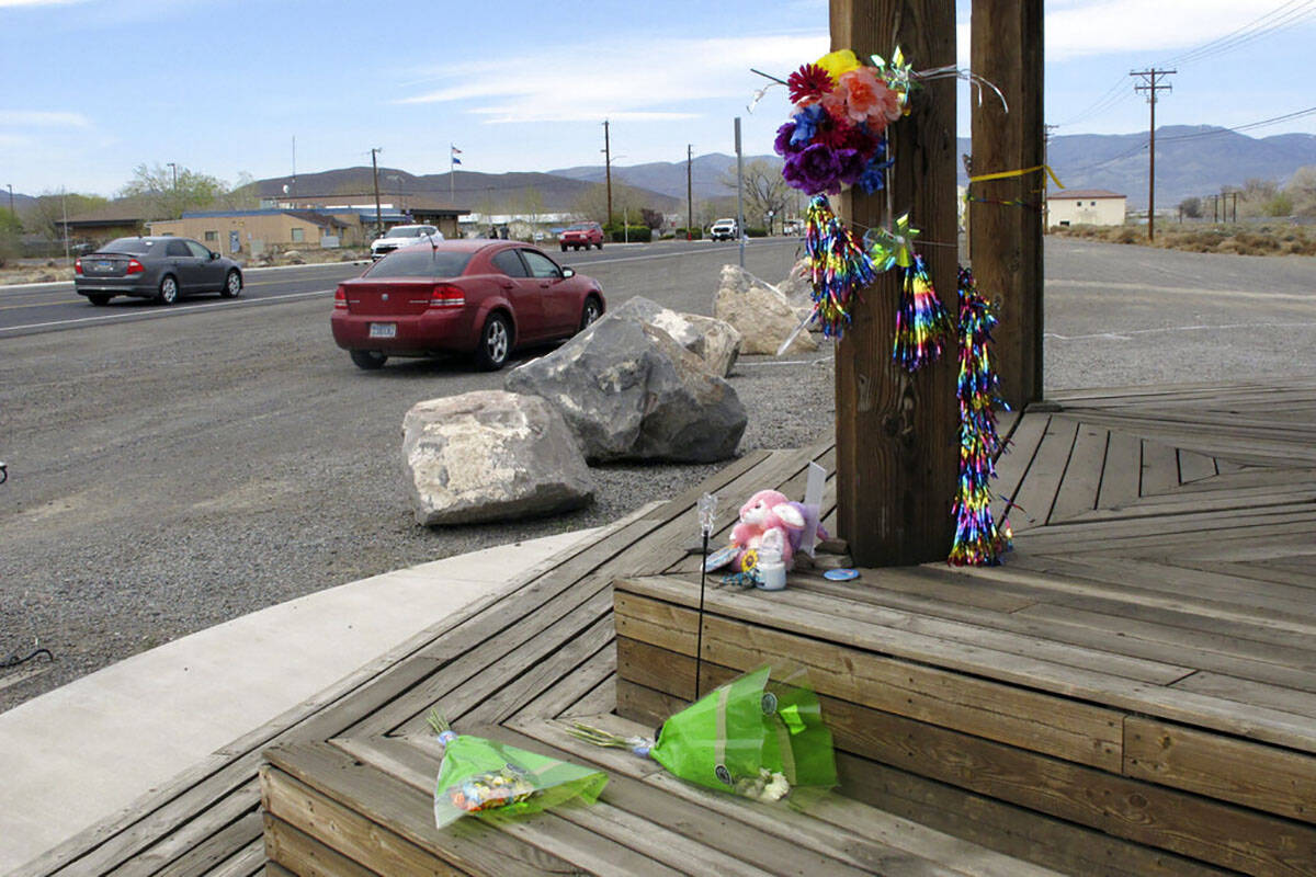 Items are left at a makeshift memorial Friday, April 8, 2022, along the main street in Fernley, ...