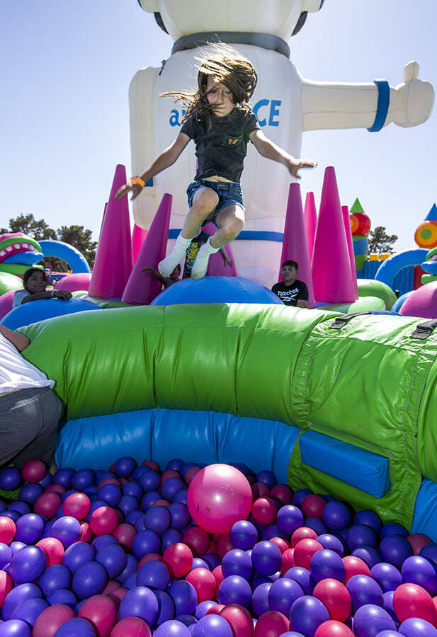 London Caseman, 9, of Las Vegas leaps into a ball pit in the Air Space Spaceman attraction at t ...