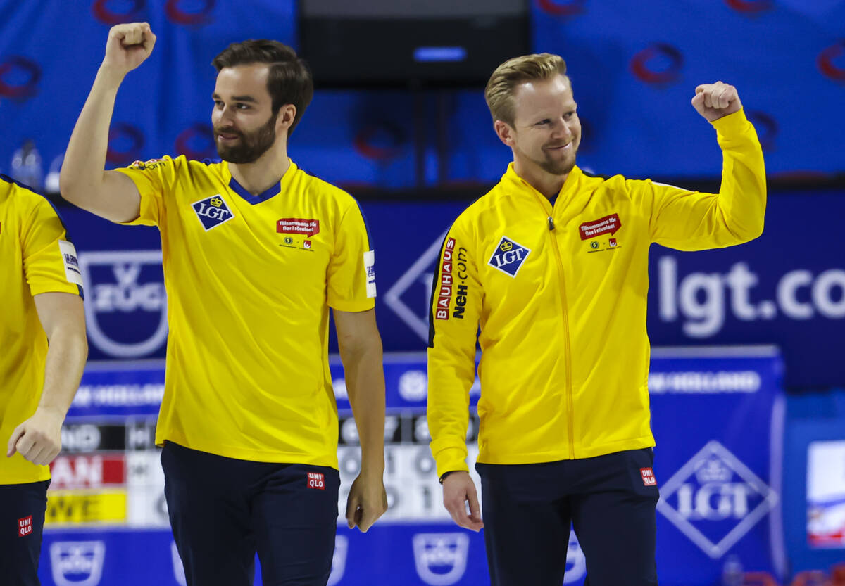 Sweden’s Oskar Eriksson, left, and with Niklas Edin celebrate after defeating Canada in ...