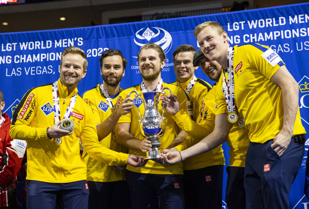 Sweden’s national team poses with the trophy after defeating Canada in the gold medal ga ...
