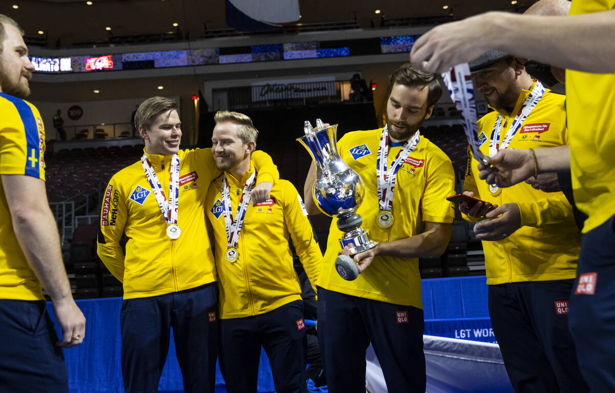 Sweden’s Christoffer Sundgren, left, celebrates with Niklas Edin as Oskar Eriksson holds ...