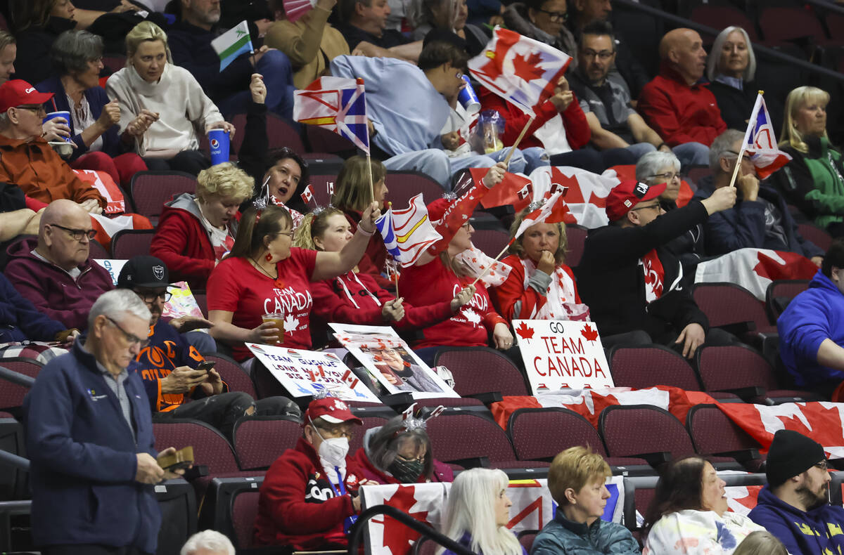 Canada fans cheer during the LGT World Men's Curling Championship final at the Orleans Arena on ...