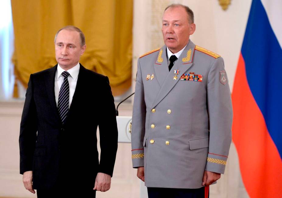 In this photo taken on March 17, 2016, Russian President Vladimir Putin, left, poses with Col. ...