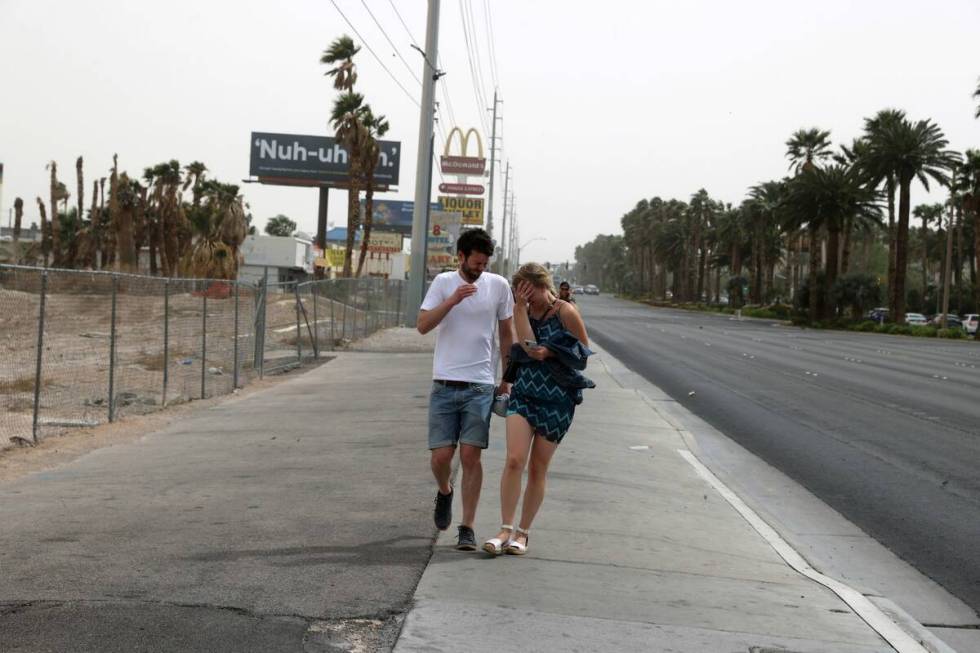 Michael Erlenkötter and Marie Kröger of Germany brace during a gust of high wind and blowing ...