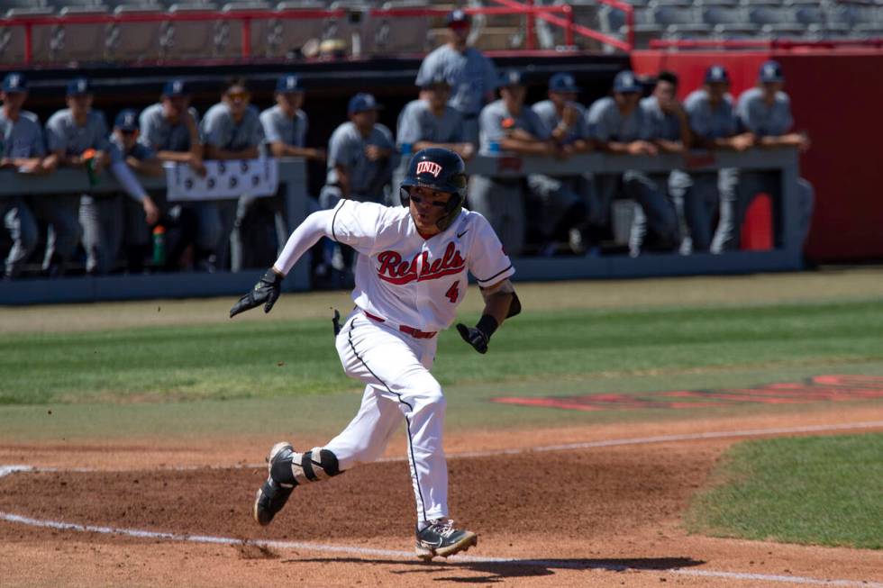 UNLV infielder Jordan Andrade (4) sprints to first base during an NCAA baseball game against UN ...