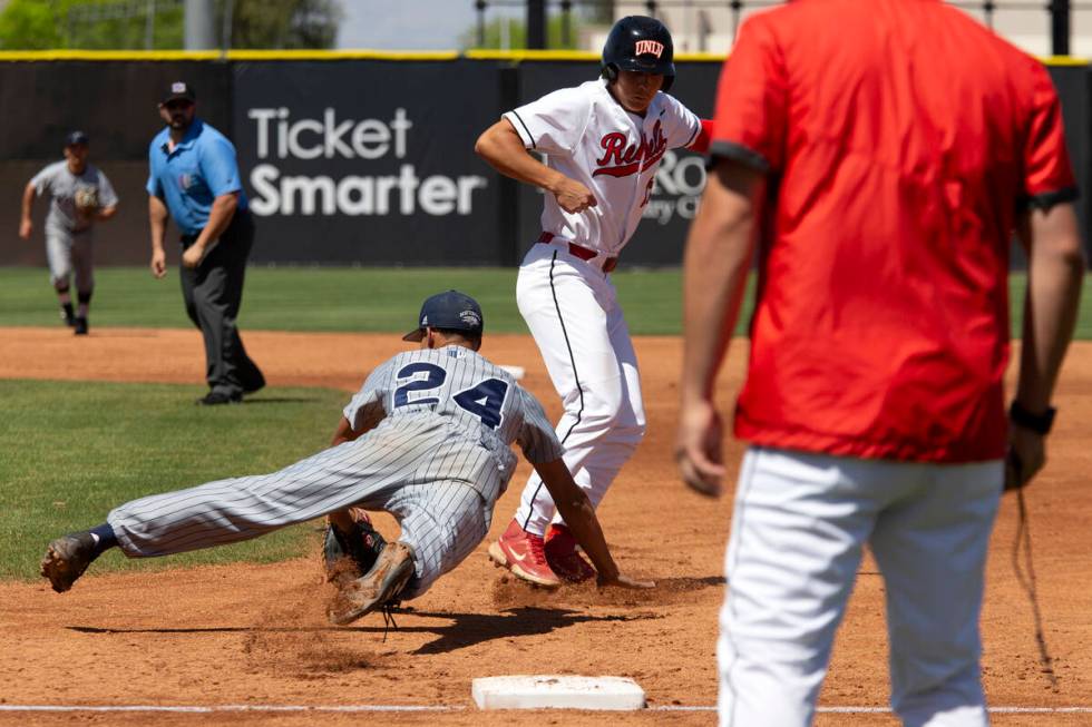 UNR first baseman Landon Wallace (24) attempts to out UNLV outfielder Rylan Charles (25) during ...