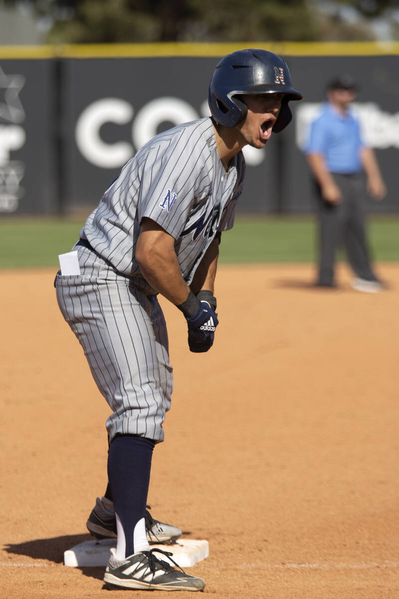 UNR outfielder Dario Gomez (10) celebrates after his hit took him to third base during an NCAA ...