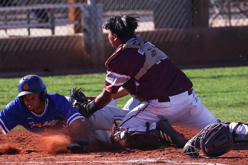 Cimarron-Memorial catcher Arturo Flores (right) is shown tagging out Bishop Gorman's Justin Cra ...