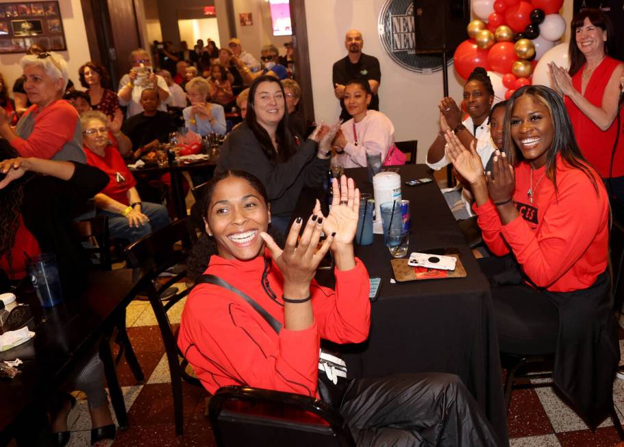 Aces players, including guard Sydney Colson, left, and center Kalani Brown cheer the Aces&#x201 ...