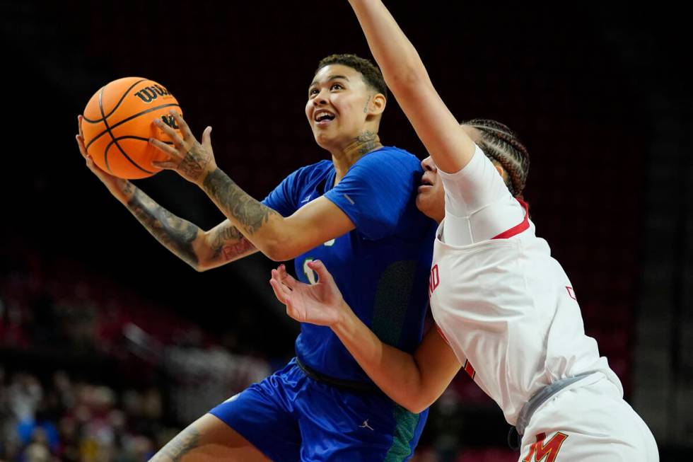 Florida Gulf Coast guard Kierstan Bell, left, goes up for a basket against Maryland forward Mim ...