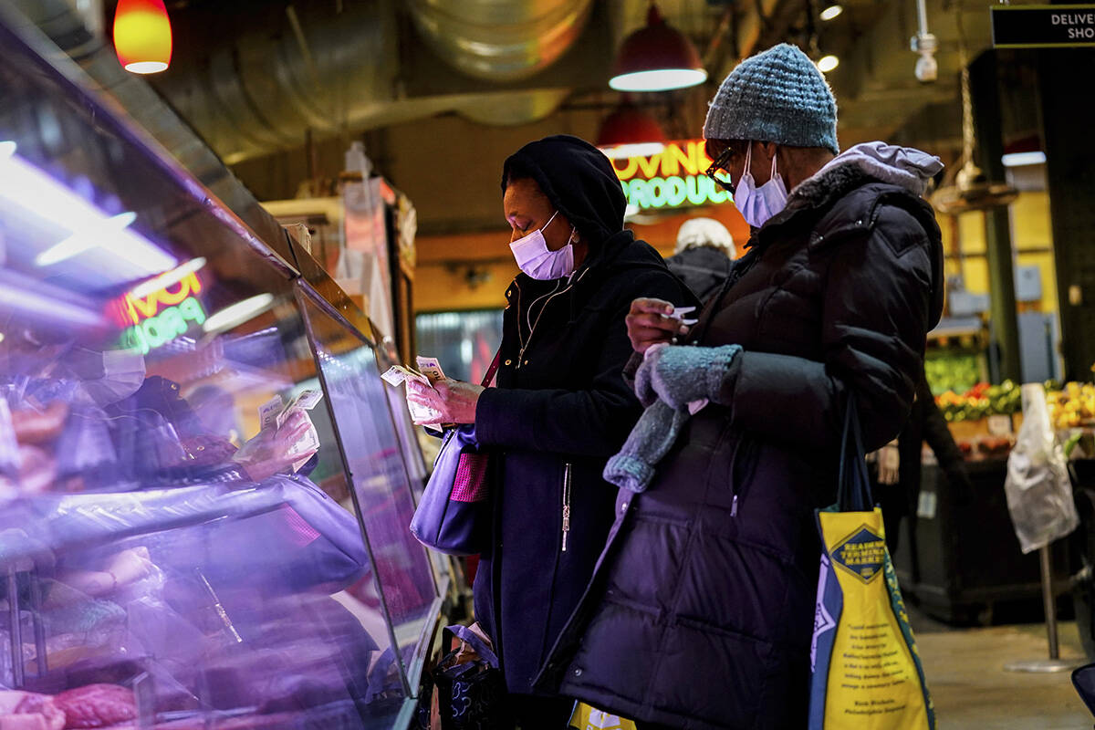 Customers wearing face masks to protect against the spread of the coronavirus shop at the Readi ...