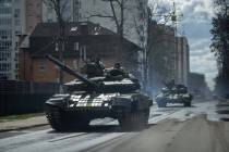 Ukrainian tanks move down a street in Irpin, on the outskirts of Kyiv, Ukraine, Monday, April 1 ...