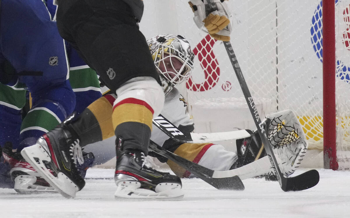 Vegas Golden Knights goalie Robin Lehner reaches to make the glove save against the Vancouver C ...