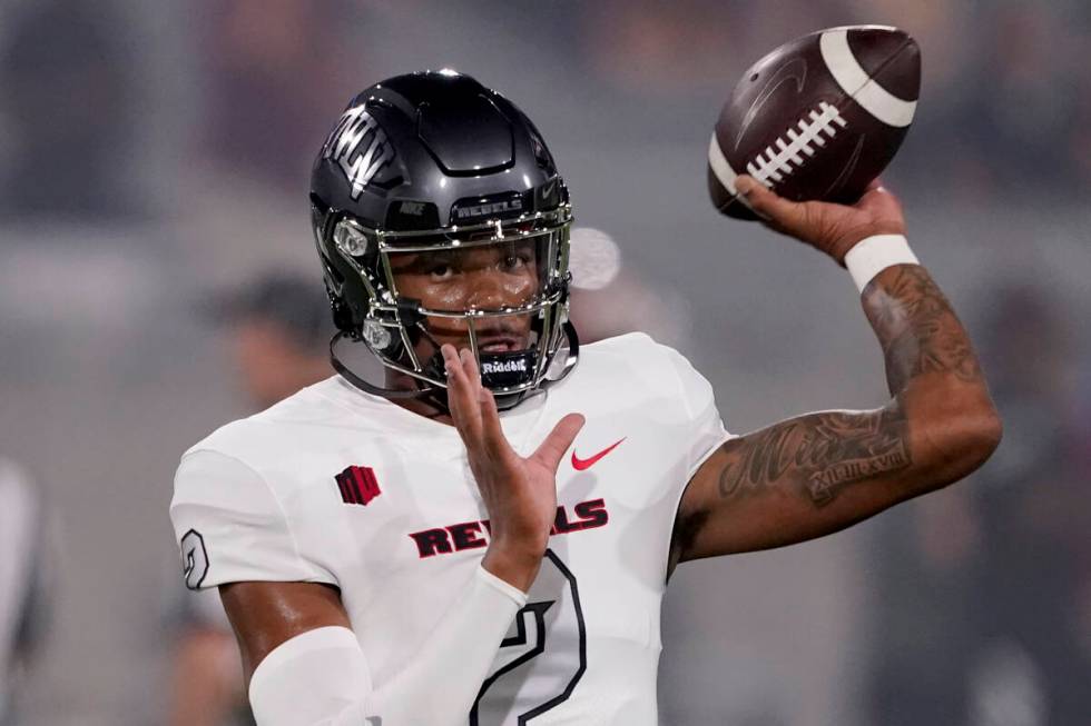 UNLV quarterback Doug Brumfield (2) warms up prior to an NCAA college football game against Ari ...