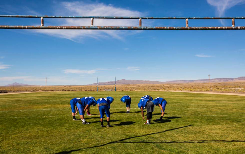 Football players stretch during practice at McDermitt High School in McDermitt in 2018. (Chase ...